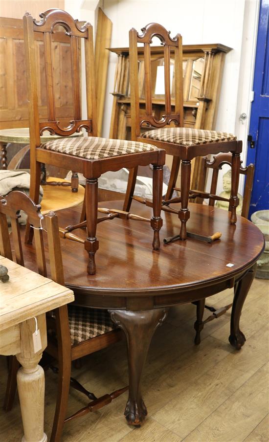 A 1920s mahogany circular extending dining table (two extra leaves) and four chairs W.141cm without leaves